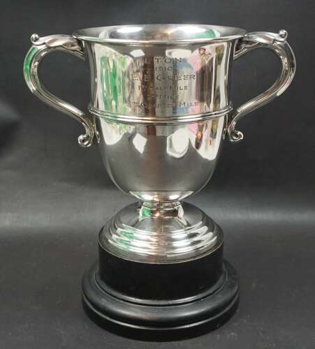 A heavy silver cup and stand awarded to EB Greer - Eton College 1910