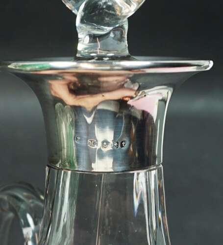 A crystal glass jug with applied green glass leaves and silver mount, Birmingham 1918